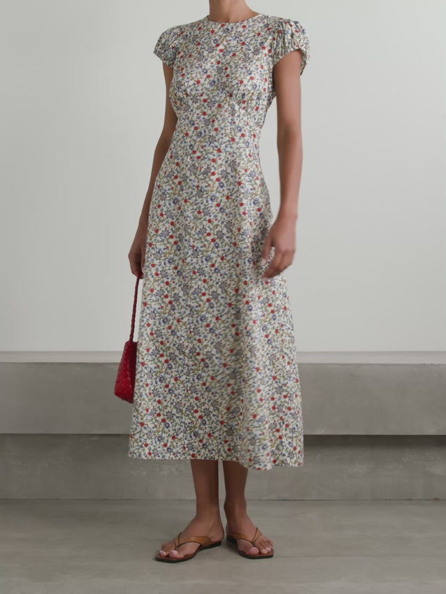 Celebrate your individuality in this Rhodia midi dress, crafted from delicate organic cotton-voile adorned with an enchanting floral print. Gathered puff sleeves add romantic dimension, while grosgrain ties at the nape can be knotted into an elegant bow for a personalized finishing touch. A timeless piece that honors the wearer's natural beauty and distinctive style.