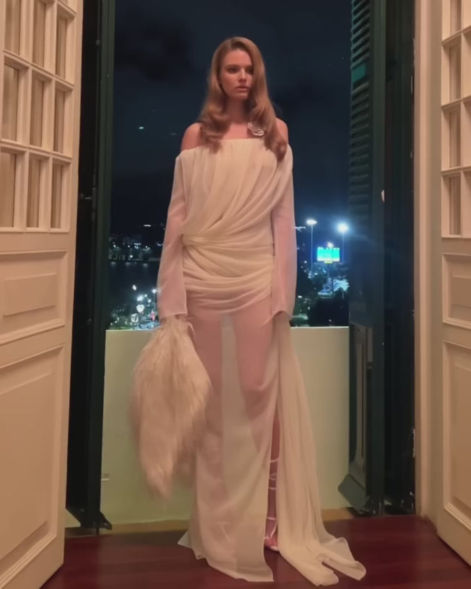 Embrace dramatic elegance with this curtain-inspired chiffon gown. Crafted from sheer, flowing chiffon fabric, this piece captures the essence of luxe draping with an effortless silhouette. The discreet back zip closure ensures a seamless fit and easy styling. Perfect for evening occasions, galas, and moments when you want to make a sophisticated statement. A timeless addition to any refined wardrobe.