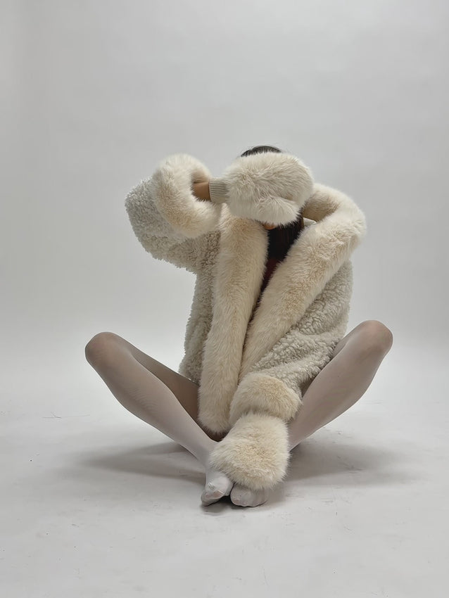 Embrace winter elegance with the Jumbo Kali White Vegan Shearling Fur Trimmed Coat—a luxurious full-length statement piece that captures timeless snow-queen sophistication. Crafted from plush faux shearling and adorned with sumptuous faux fur trim along every hem, this coat radiates drama and refinement. The satin lining and generously cut sleeves offer effortless layering and all-day comfort, while secure front hooks provide both style and function through the coldest season. 