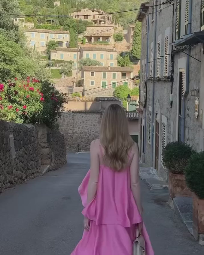 The Tilly Tiered Maxi Dress in Pale Pink is a graceful choice for bridesmaids, weddings, or special celebrations. Its flowing tiered skirt creates gentle layers that move beautifully with every step, adding a romantic and feminine touch. Made from lightweight textured satin, this gown offers a subtle sheen while remaining comfortable for all-day wear. Thin adjustable straps allow for a perfect fit, giving support and flexibility for long events. 
