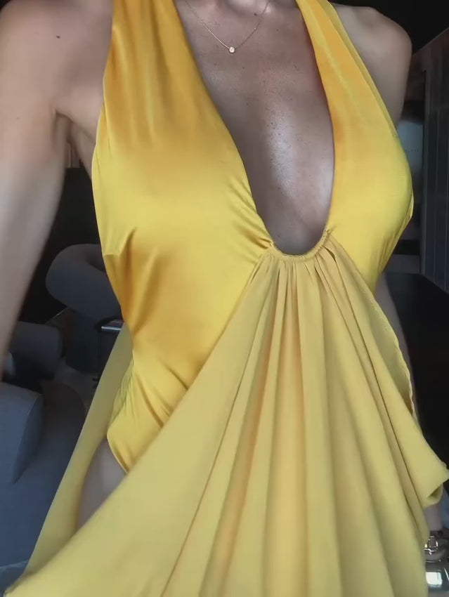 Wrapped in a luxurious saffron tone, the Mina Maxi embodies understated sophistication and vacation-ready charm. A fitted stretch bodysuit anchors this design, flowing into a gracefully draped chiffon skirt that sways with natural movement. The sheer, unlined chiffon delivers an effortlessly refined aesthetic with an airy, breathable quality. With its streamlined silhouette, this dress glides from sun-soaked beach moments to elegant evening affairs. 