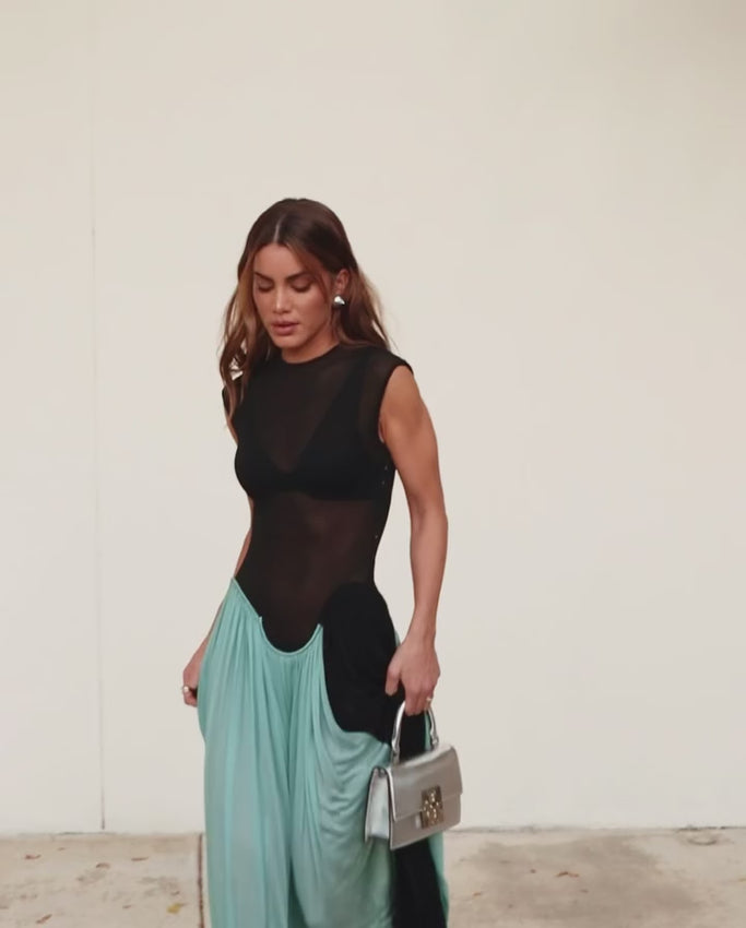 Introducing the Eileen Maxi Dress - the perfect combination of sexy and elegant. This sleeveless dress features a transparent design, perfect for a night out on the town. With its draped pleat details, you'll be sure to turn heads at any party. Embrace your inner fashionista and rock this dress with confidence.