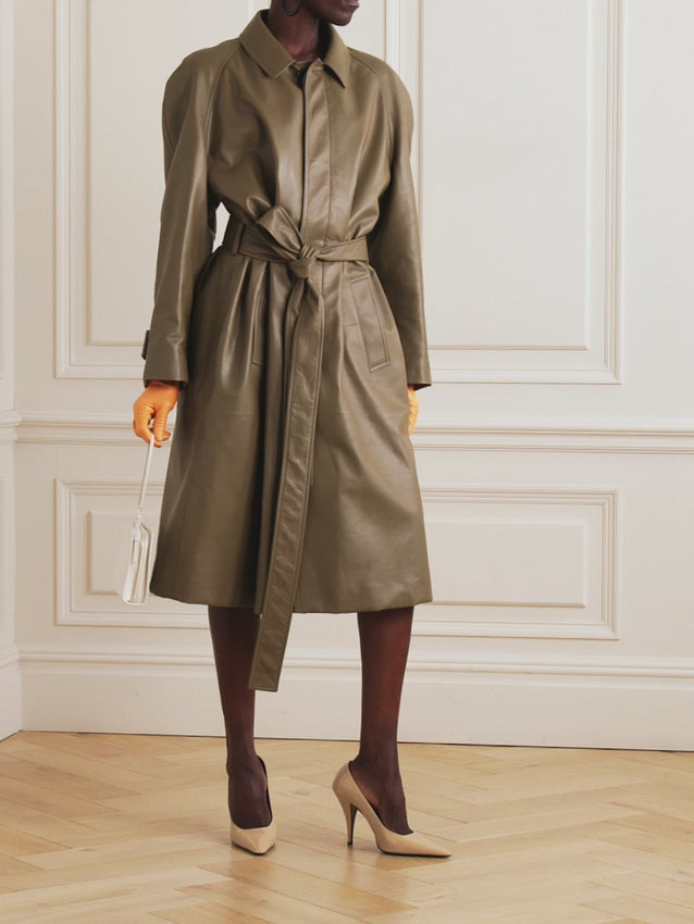 Indulge in luxury with the Devitt Coat by The Row- a perfect blend of style and warmth. Crafted from a soft wool and silk blend, this knee-length coat features a padded design and removable belt for a flattering silhouette. The hidden front placket adds a touch of sophistication to this exclusive piece from The Row.