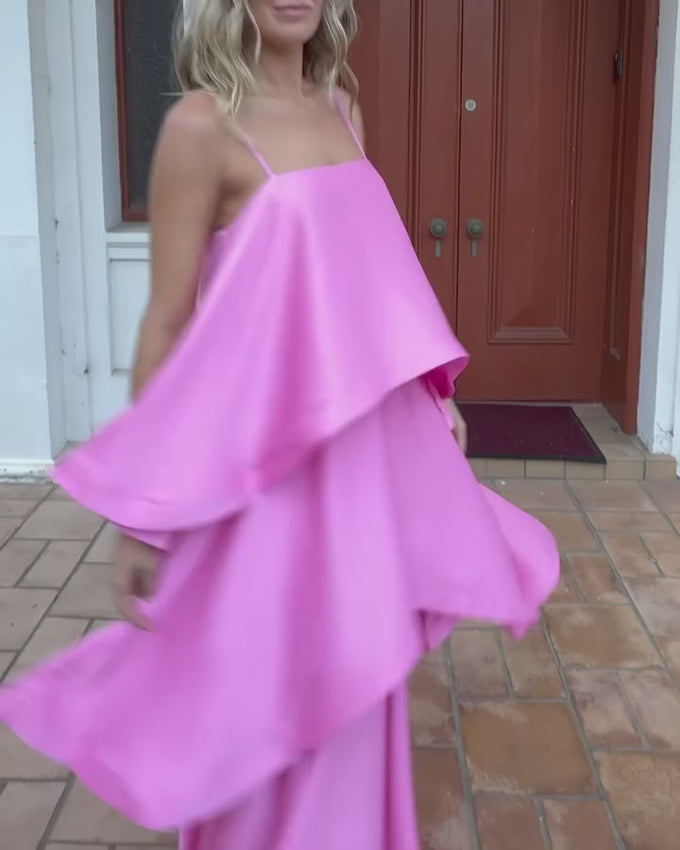 The Tilly Tiered Maxi Dress in Pale Pink is a graceful choice for bridesmaids, weddings, or special celebrations. Its flowing tiered skirt creates gentle layers that move beautifully with every step, adding a romantic and feminine touch. Made from lightweight textured satin, this gown offers a subtle sheen while remaining comfortable for all-day wear. Thin adjustable straps allow for a perfect fit, giving support and flexibility for long events. 