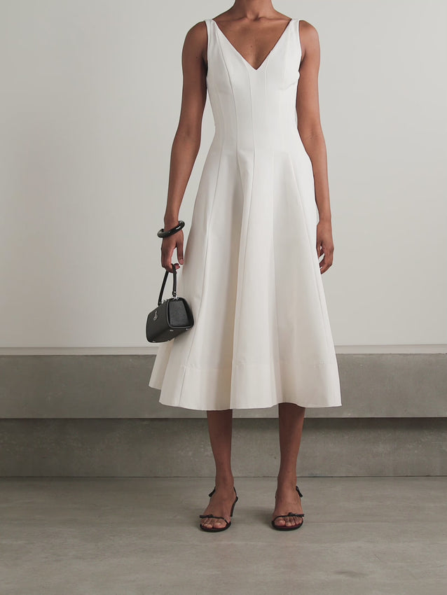 The Marieta midi dress by Staud combines refined elegance with everyday wearability. Crafted from a luxurious cotton-blend faille fabric, this sophisticated piece features strategic paneling that creates a flattering silhouette. The midi length offers timeless versatility, transitioning seamlessly from professional settings to evening occasions. The structured faille weave provides subtle texture and movement, while the thoughtful panel construction ensures a polished, put-together appearance. 