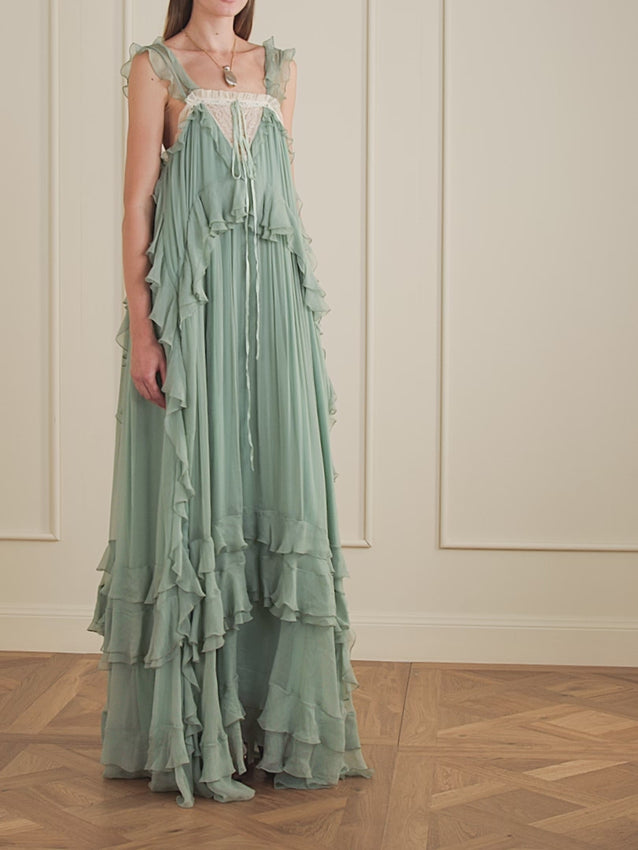 Channeling the elegance of Chemena Kamali, this Chloé gown captivates with its signature soft ruffles and refined craftsmanship. The luxurious silk crêpon fabric drapes beautifully, while delicate lace adorns the neckline with graceful precision. A ribbon accent completes this timeless piece—perfect for those seeking understated sophistication and effortless French-inspired style.