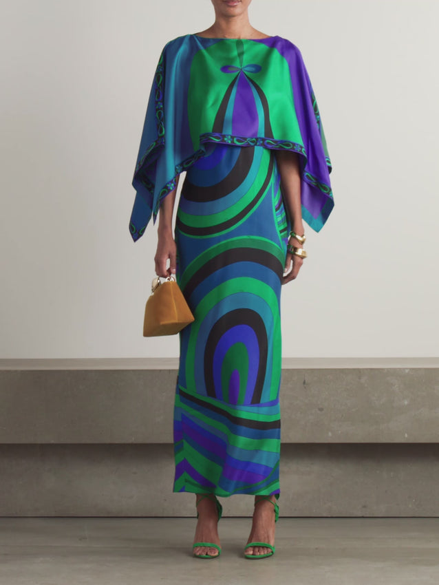 Inspired by the iconic aesthetic of Pucci, this layered silk-twill maxi dress showcases vibrant printed patterns that capture the essence of timeless elegance. The flowing silhouette and luxurious fabric create an effortlessly sophisticated look, perfect for special occasions or elevated everyday wear. The intricate layering adds depth and movement, while the maxi length offers graceful coverage. A statement piece that embodies refined femininity and artistic design.