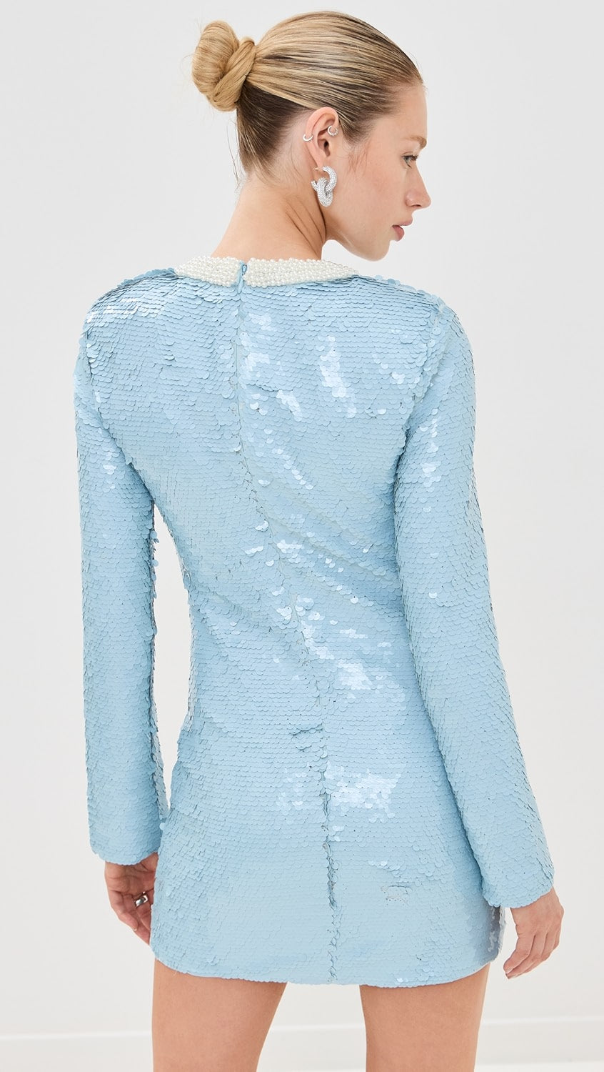 Elevate your style with the Blue Sequin Mini Dress! This mid-weight, non-stretch sequined mesh dress features contrast beaded trim, padded shoulders, and a mini length for a dazzling look. With a crew neck, long sleeves, and hook-and-eye and hidden zip closure at the back, this dress is both chic and comfortable.