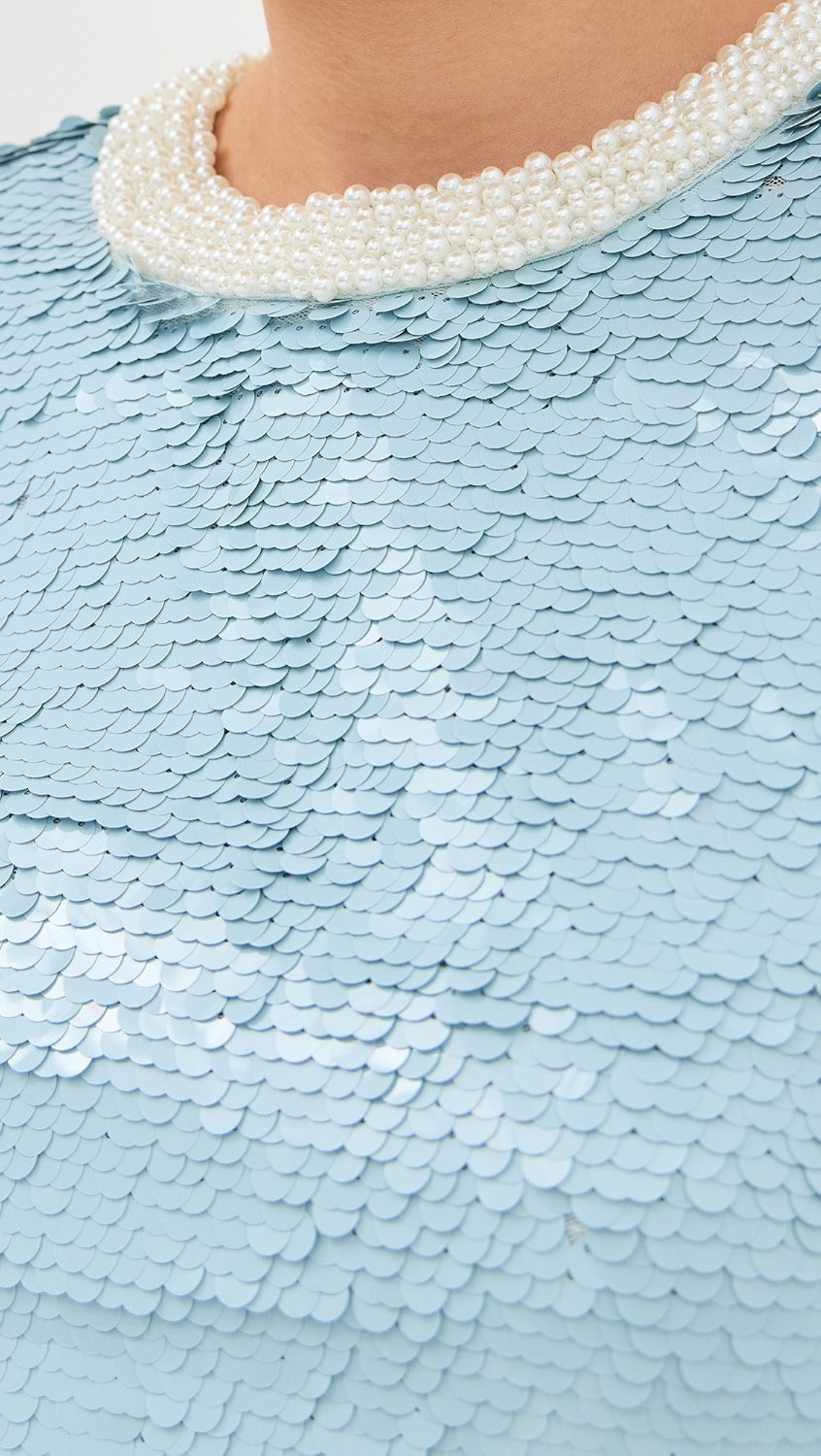 Elevate your style with the Blue Sequin Mini Dress! This mid-weight, non-stretch sequined mesh dress features contrast beaded trim, padded shoulders, and a mini length for a dazzling look. With a crew neck, long sleeves, and hook-and-eye and hidden zip closure at the back, this dress is both chic and comfortable.