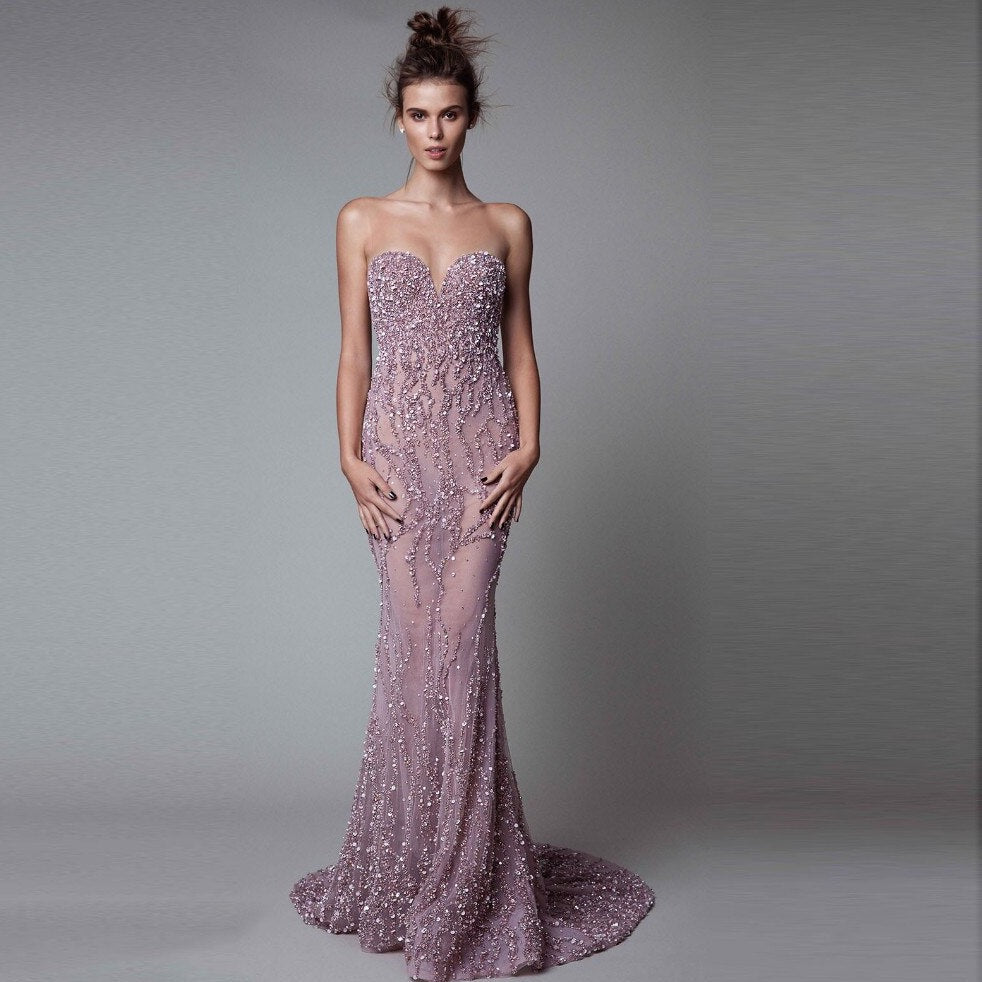Effortlessly turn heads in the Robe Eadouin. Detachable sleeveless mermaid style and sparkling purple gown create a look of pure elegance and luxury. Feel like a goddess and wow at any special event with this show-stopping gown!