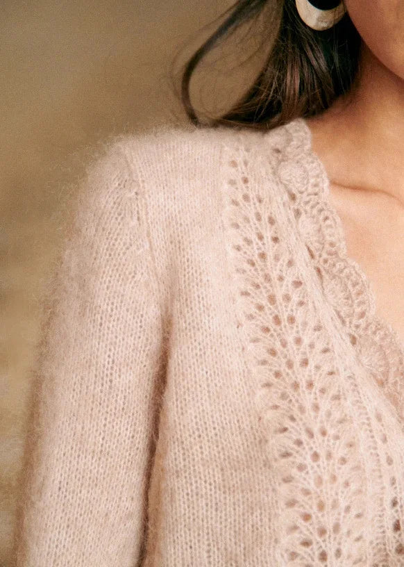 Introducing the Cardigan Angelie, a delicate wool blend cardigan perfect for spring and summer. Designed with gentle crochet knitted details, this cardigan offers both style and comfort. Stay fashionable and cool with this must-have addition to your wardrobe.