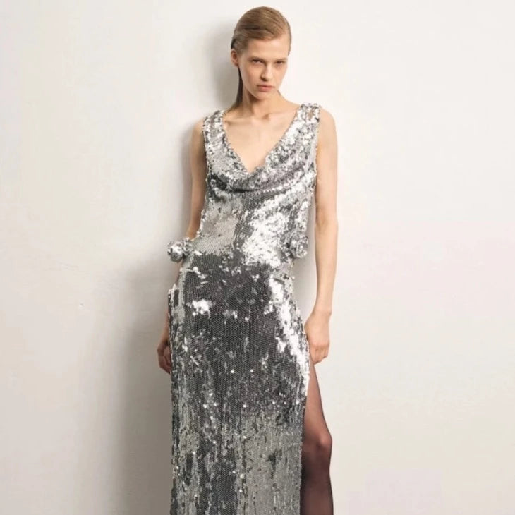 Indulge in luxury with the handnetted sequins and 3D rose appliqué of the Magda Butrym cowl neck dress. Crafted with a plunging neckline and draped back, this silver creation exudes elegance and sophistication. Take center stage and make a statement with this exclusive piece.