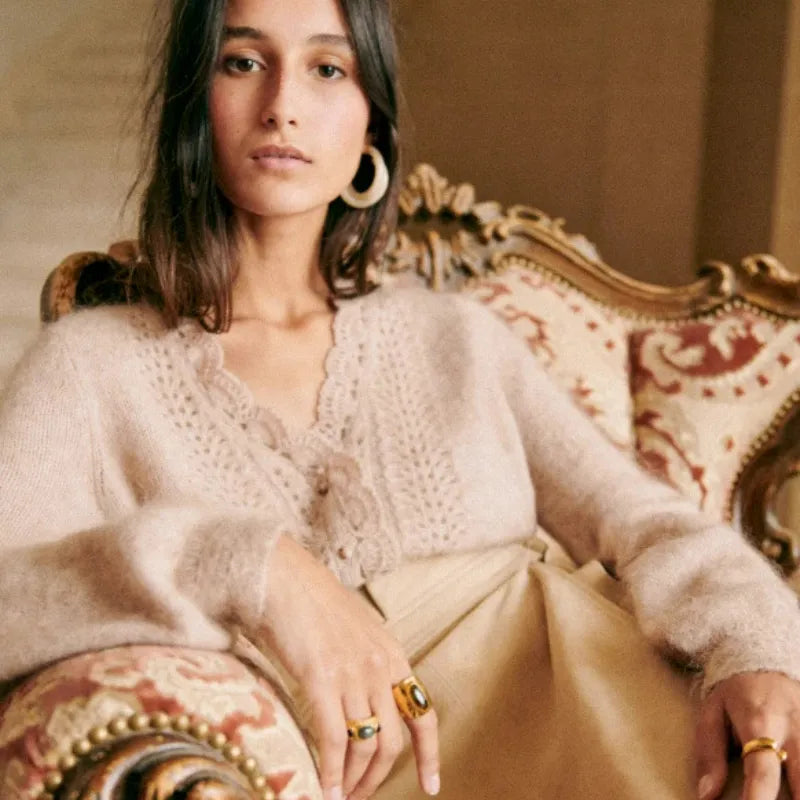 Introducing the Cardigan Angelie, a delicate wool blend cardigan perfect for spring and summer. Designed with gentle crochet knitted details, this cardigan offers both style and comfort. Stay fashionable and cool with this must-have addition to your wardrobe.