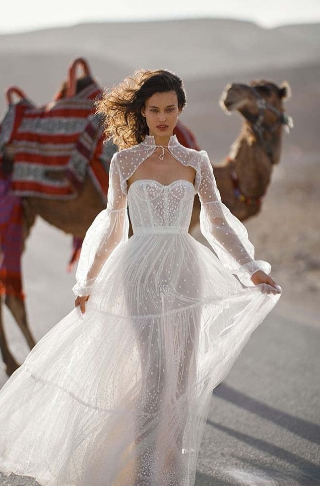 Expertly crafted from delicate white lace, the Robe Indhira is the perfect gown for your special day. Designed to make you feel elegant and beautiful, this bridal gown is made with intricate lace details that will capture everyone's attention. Make a statement with this stunning wedding dress.