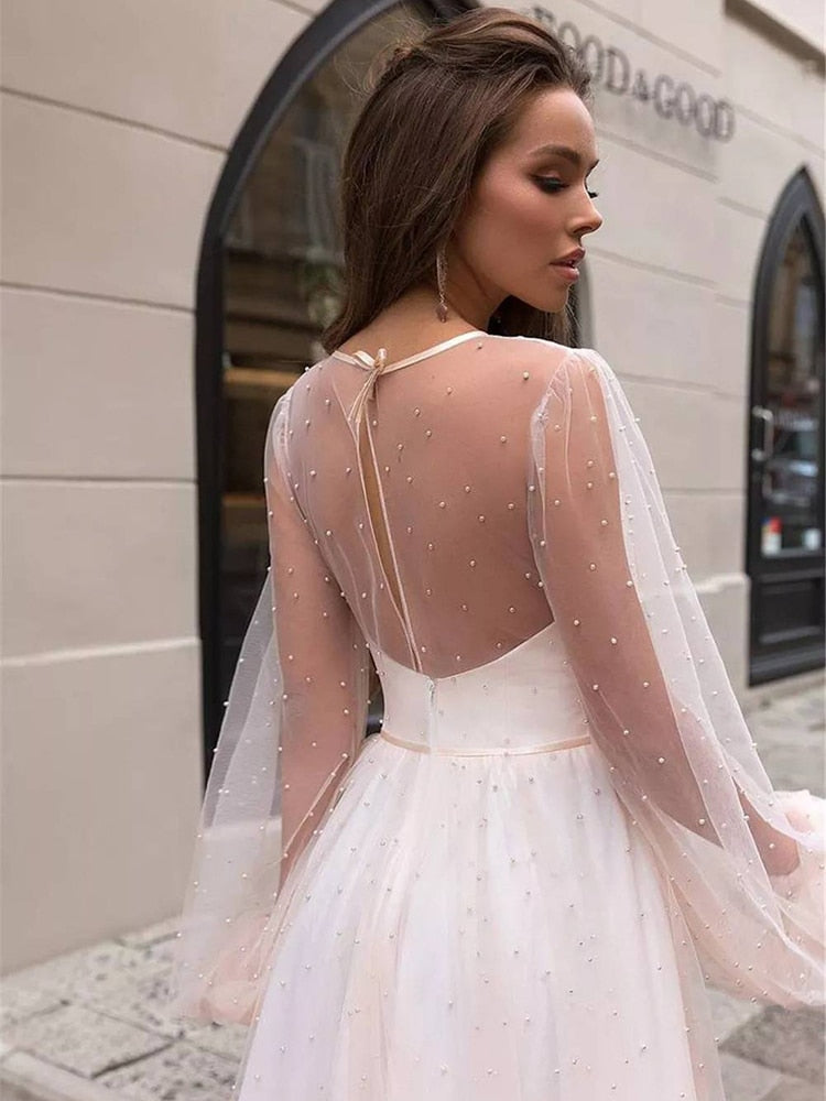 As a bridal industry expert, I introduce the elegant Robe Lumi, an A-line bridal gown designed to enhance your natural figure. Its timeless silhouette will provide a sophisticated yet romantic look for your special day. Experience the perfect blend of modern elegance and traditional beauty with Robe Lumi.
