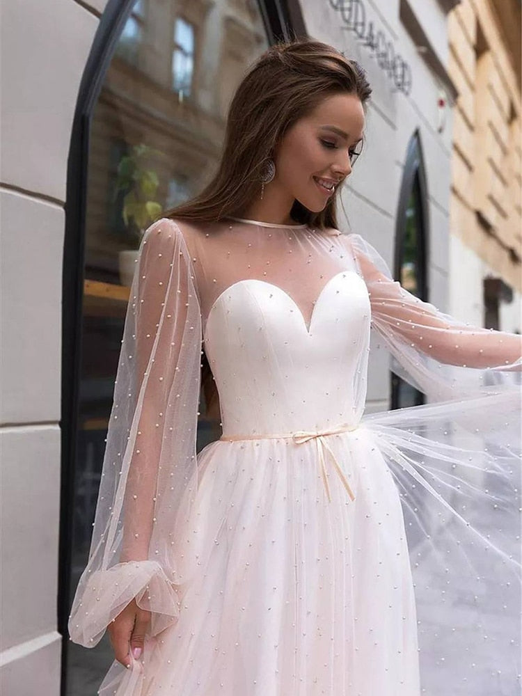 As a bridal industry expert, I introduce the elegant Robe Lumi, an A-line bridal gown designed to enhance your natural figure. Its timeless silhouette will provide a sophisticated yet romantic look for your special day. Experience the perfect blend of modern elegance and traditional beauty with Robe Lumi.