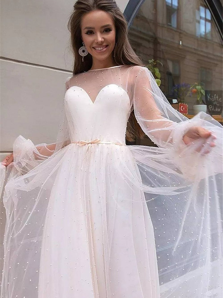 As a bridal industry expert, I introduce the elegant Robe Lumi, an A-line bridal gown designed to enhance your natural figure. Its timeless silhouette will provide a sophisticated yet romantic look for your special day. Experience the perfect blend of modern elegance and traditional beauty with Robe Lumi.